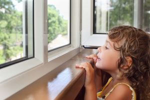 Little Girl Looking Out Windows