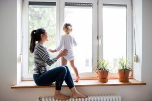 Woman & child looking out clean windows