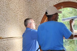 Charles with Jerry Robbins Cleaning Bathroom Window